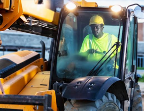 Operator climbing onto a heavy loader