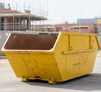 Yellow waste skip bin